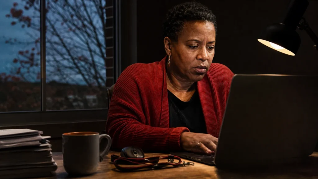A practice owner sits at a lamp-lit desk at dusk, hands on a laptop, about to decide what to write. (AI-generated image) A practice owner sits at a lamp-lit desk at dusk, hands on a laptop, about to decide what to write. (AI-generated image)